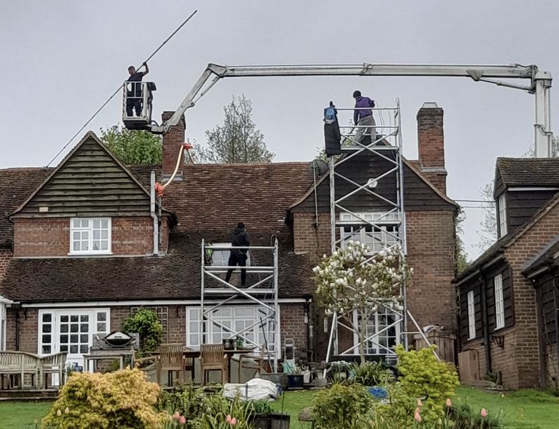 The Moss Cleaners using cherry picker and scaffolding to clean roof safely and professionally in Coleshill, Warwickshire